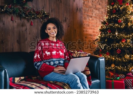 Photo of cheerful peaceful girl sit sofa use wireless netbook new year tree lights decor loft interior house inside