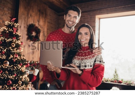 Photo of attractive sweet family husband wife wear ugly sweaters relax rest enjo magic moments christmas time using computer for shopping