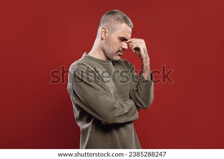 thoughtful man with fingers touching his nose Royalty-Free Stock Photo #2385288247