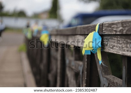 Ribbons in the colors of the national flag of Ukraine are tied to the handrail. Yellow-blue tapes