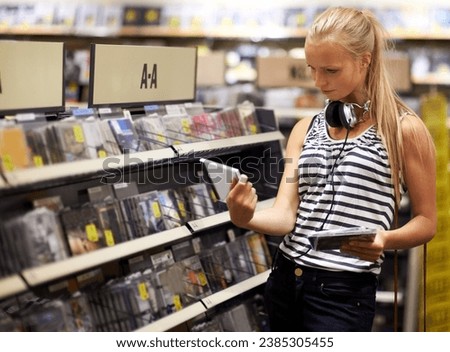 Woman, customer or shopping for music disc, cd or album in store playlist selection, decision and choice. Thinking student, person and musician with headphones reading multimedia information by shelf Royalty-Free Stock Photo #2385305455