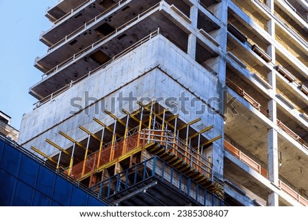 There is construction site where new skyscraper buildings are being built for large American cities. Royalty-Free Stock Photo #2385308407