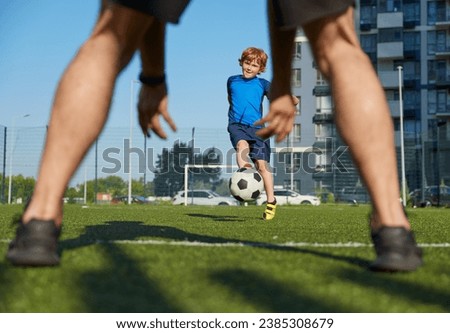 Father and son playing family football summer camp at city stadium Royalty-Free Stock Photo #2385308679