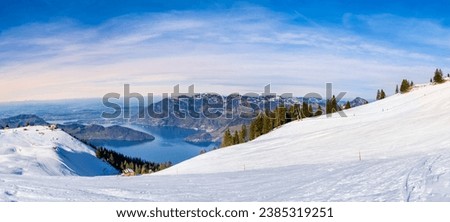 Panorama of Klewenalp mountains and Lake Lucerne or Vierwaldstattersee from mountain peak covered with snow. Popular ski resort in Swiss Alps and winter sport attraction in Switzerland in winter.