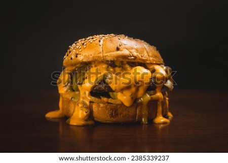delicious and greasy burger with melted chedar cheese Royalty-Free Stock Photo #2385339237