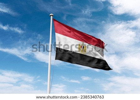 Egypt flag waving at cloudy sky background. Arab Republic of Egypt flag.