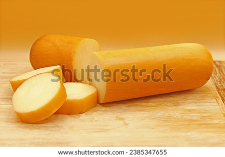 SLICED PROVOLONE CHEESE ON WOODEN BOARD Royalty-Free Stock Photo #2385347655