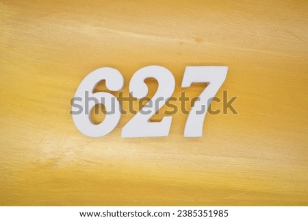 The golden yellow painted wood panel for the background, number 627, is made from white painted wood.