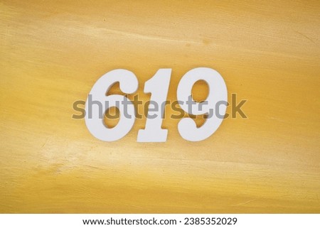 The golden yellow painted wood panel for the background, number 619, is made from white painted wood.