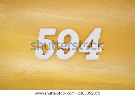 The golden yellow painted wood panel for the background, number 594, is made from white painted wood.