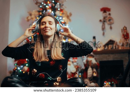 
Happy Woman Listening to Christmas Songs at Home
Cheerful girl enjoying Xmas carols alone in her Livingroom
