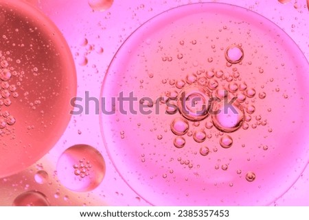 Pastel drops of oil or serum texture background. Abstract yellow fluid with bubbles Royalty-Free Stock Photo #2385357453