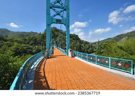 A steel-structured bridge with colorful scenery and beautiful scenery. There is a Chinese character for bridge in the picture: Fuxing Bridge.