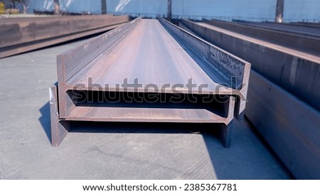 Steel beams production. Metal girders stack on project construction , steel h-beam, selective focus, Raw materials used in building construction. Royalty-Free Stock Photo #2385367781