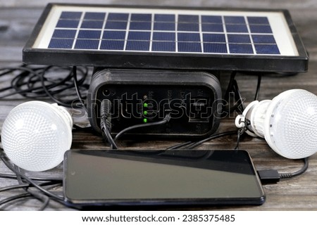 A multi purpose battery charged with a solar panel, a device that converts sunlight into electricity by using photovoltaic (PV) cells, with charging cell phone through USB port and connected led light