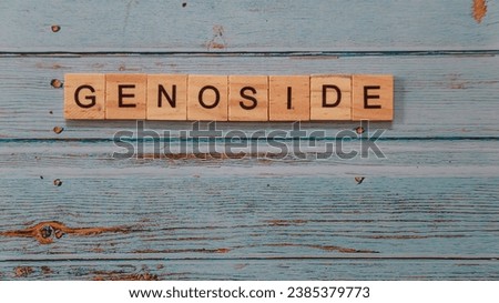 wooden tile spelling word GENOSIDE