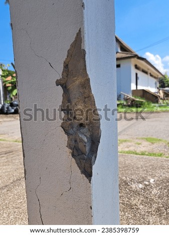 Cracks in damaged building pillars. Cracked concrete pillar of an old house. Deep and clear fractures, on the front surface of an old cement pillar. Royalty-Free Stock Photo #2385398759