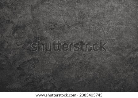Texture of black polished concrete background. Dark old wallpaper with cement texture. Nature wall concept, surface mockup. Empty rough cement wall or floor background. Top view, close up, copy space