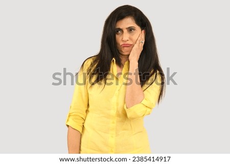 Indian funny woman with crazy expression posing in funny moods on using hands moments Isolated on studio background. funny facial expressions, shocking puffing cheeks with funny face. Mouth inflated  Royalty-Free Stock Photo #2385414917