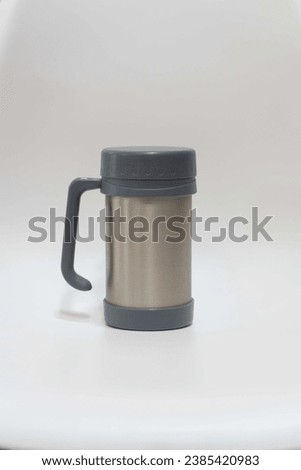 Stainless steel coffee mug on white background. Aluminum thermos mug isolated on white