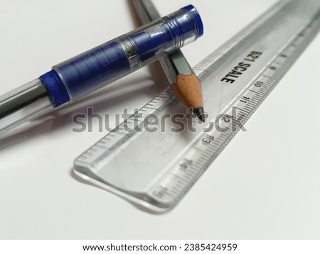 Blue pen and pencil on white background - Minimalist school supplies in vibrant colors.