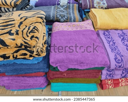 pile of towels for sale at the market