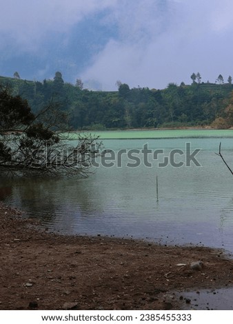 Portrait of dieng plateau beautiful vibrant lake with blue cloudy sky. Wonosobo, Central Java, Indonesia