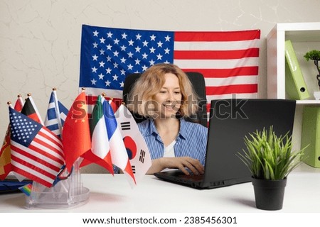 Language school online, teacher with laptop in the classroom with different flags