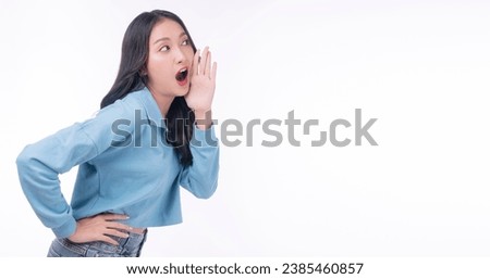 Excited asian woman shouting wow shock sale holding hand beside mouth standing over isolated white background. Surprise young girl scream hurry up to empty amazed news or sale advertisement.Expression