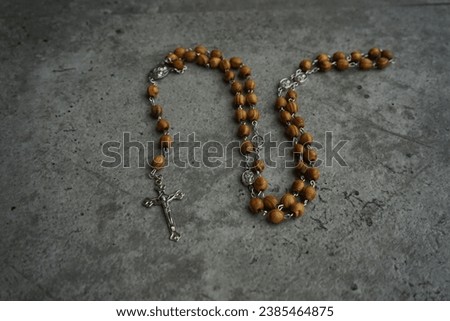 Catholic rosary with corpus on gray background