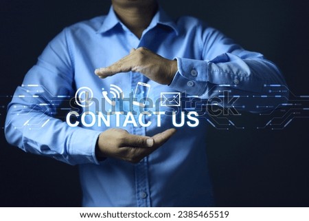 Contact us concept with businessman hand holding contact icon email social media chanel online devices to provide question and answer for customer services on products inquiry information