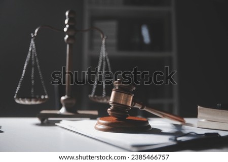 Business and lawyers discussing contract papers with brass scale on desk in office. Law, legal services, advice, justice and law concept picture with film grain effect Royalty-Free Stock Photo #2385466757