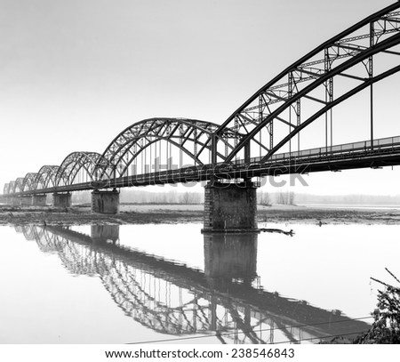 The iron "Gerola Bridge" on the Po river, Lombardy (Northern Italy, in the Province of Pavia). Black and white photo