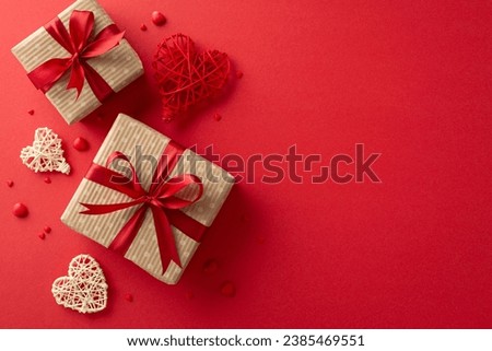 Express your love on Valentine's Day with a top view of craft paper gift boxes, rustic hearts, sprinkles and red background to convey your greeting message or promotion