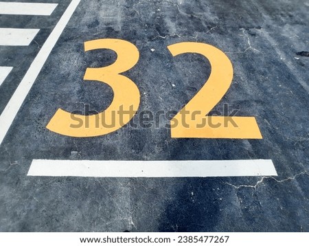 Number 32 on road surface, traffic sign