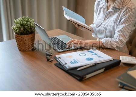 Cropped image of a businesswoman working in her office, working on her financial project or responding to an email on her laptop.