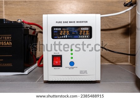 Emergency power supply with a 12V 65Ah battery providing uninterrupted pure sinusoidal alternating voltage of 230 Volt. Royalty-Free Stock Photo #2385488915