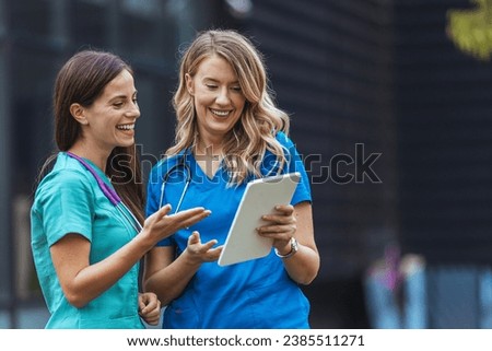 Nurses walking and talking. Diversity workers, smile and happy medical healthcare teamwork on treatment collaboration. Shot of two young nurses talking outside 