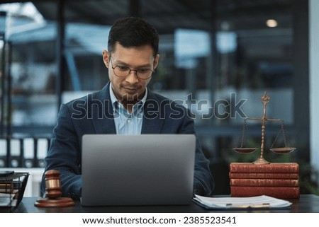 Serious pensive lawyer working at desk in office.