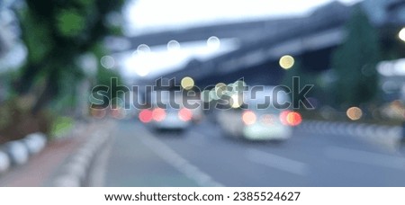 abstract background that does not focus on the atmosphere on a highway where many vehicles such as cars and motorbikes pass in the morning
