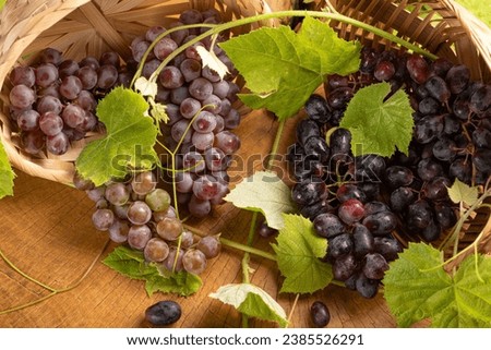 Grapes, basket with beautiful grapes, on rustic wood, selective focus.