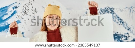 cute preteen girl in stylish jacket with present bags smiling at camera, fashion concept, banner Royalty-Free Stock Photo #2385549107