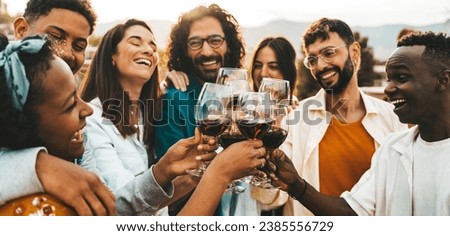 Young people toasting red wine glasses at farm house vineyard countryside - Happy friends enjoying happy hour at winery bar restaurant - Guys and girls having rooftop house party together