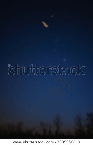 Silhouette of a countryside with Milky Way starry skies - out of focus photo suitable for background.