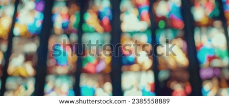 Stained glass windows art in church. Blurred cathedral background.