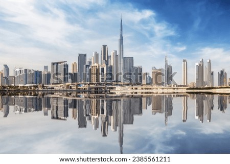 The urban skyline of Dubai Business bay with reflections of the modern skyscrapers in the water, UAE