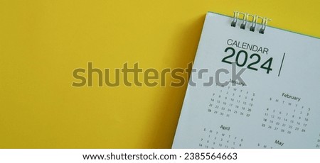 close up top view on calendar 2024 month schedule to make appointment meeting or manage timetable each day lay on orange background for planning work and life concept Royalty-Free Stock Photo #2385564663