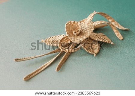 Decoration of straw on the green background. Branch with flowers. Decor