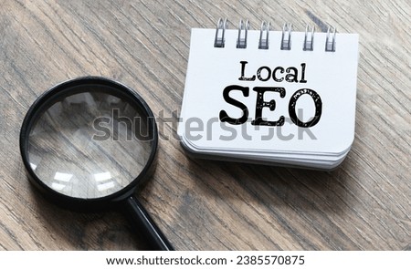 Local SEO write on notepad isolated on Wooden Table.