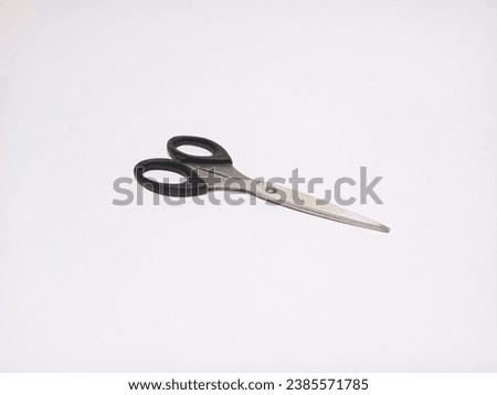 Stainless steel scissor with black handle. isolated white background